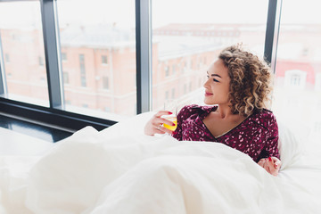 Woman on Hotel Bed Covering Self With Sheet.