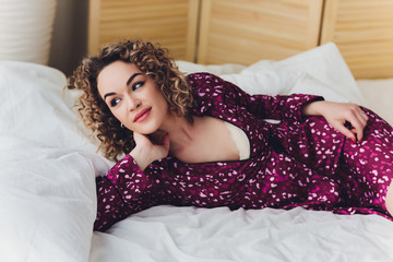Woman on Hotel Bed Covering Self With Sheet.
