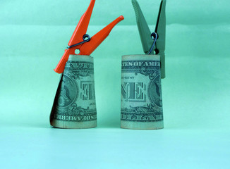 
two bills clamped by clothespins lie on a table