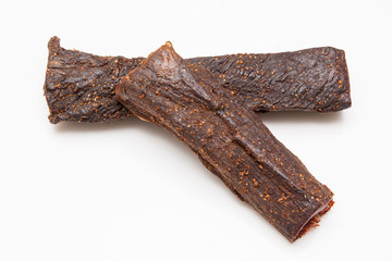 Beef Biltong, South African Beef Jerky isolated on a white studio background.