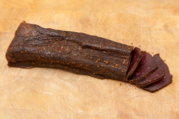 Beef Biltong South African Beef Jerky on wooden background.