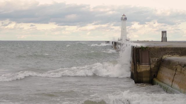 Extreme Waves Crashing On The Lakeshore Of Lake Ontario In Western New York With The Famous Sodus Point Lighthouse During Lake Flooding - Wide Shot