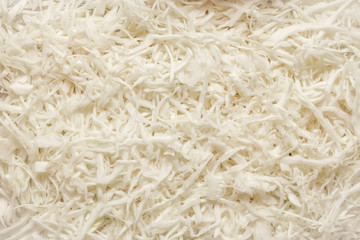 Sliced white fresh cabbage laid out on a table