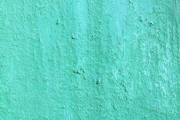 Beautiful vintage blue background with old blue paint with a rough surface, streaks and uneven texture of blue paint on an old rough surface
