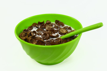 a bowl of choco crunch with delicious milk with a green bowl