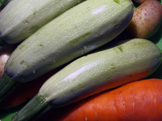 Vegetable still life, fresh zucchini, carrots and potatoes, close-up. Natural products, healthy food concept.