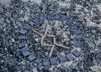 Norse rune Ingwaz on ashes backgorund inside the circle of 24 Norse runes.