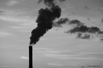 Black smoke from an industrial chimney as a symbol of environmental pollution
