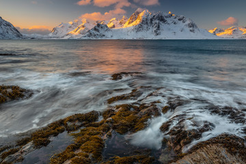 Soft tones of the golden hour in mountains at the coast of Vareid, Lofoten, Norway
