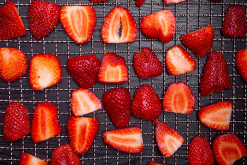 sliced strawberries in dehydrator trays