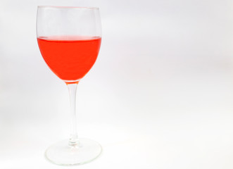 Glass goblet with red wine on a white background. Place for text