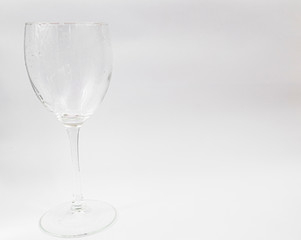 Clean wine glass on a white background. Place for text