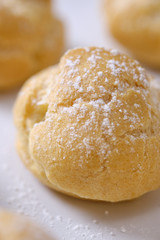 choux cream or cream puff or French profiteroles with fresh cream set on cafe table.