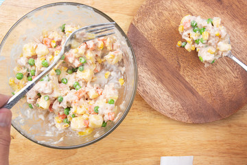 Chef putting Tuna corn salad to the plate