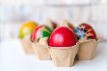 Colorful eggs in a cardboard tray top view. Easter. Holiday concept. Selected focus.