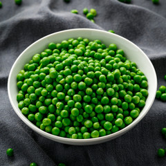 Green peas in white bowl. Healthy food