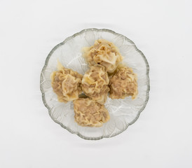 Chinese traditional delicacies, fresh meat wontons on clear plate isolated on white