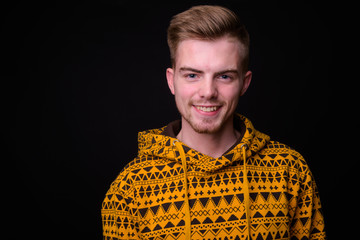 Portrait of young blond bearded man wearing hoodie