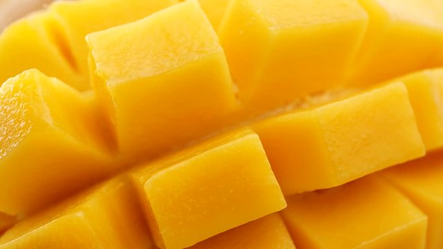 Close-up slides mangoes. Organic tropical fruits, Fresh Sliced Mango Squared rotation in 4k slow motion