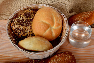 crunchy buns with grains and a glass of natural water