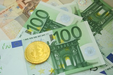 Golden bitcoin coin on euro bankcote. Finance and banking concept. Economy investment.
