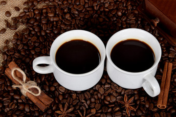two white cups with black coffee