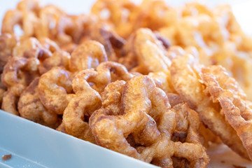 Making deep fried rosette cookies