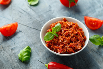 Sun dried tomato pesto in white bowl.