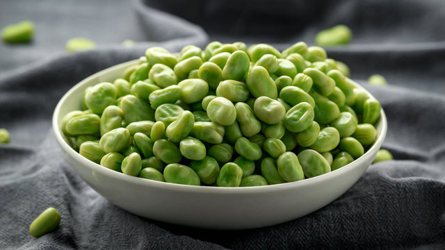 Green Broad Beans in a white bowl. healthy food