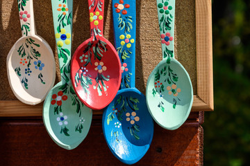 Many hand made painted wooden spoons with traditional decorations displayed for sale as souvenirs at a street market fair in Bucharest, Romania
