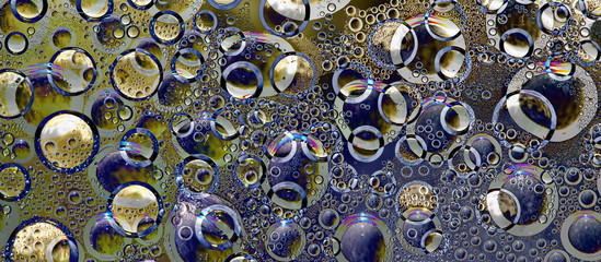 Yellow and turquoise spheres are located on a multi-colored background with holes of different diameters. Space abstraction. 