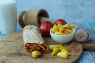 Doner kebab (shawarma or doner wrap). Grilled chicken on lavash (pita bread) with tomatoes, green...