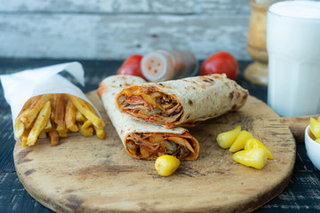 Doner kebab (shawarma or doner wrap). Grilled chicken on lavash (pita bread) with tomatoes, green...