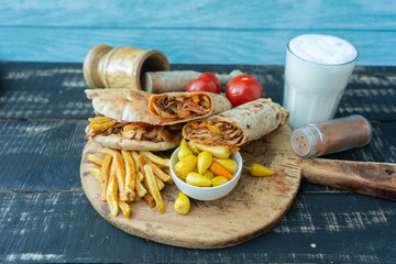 Doner kebab (shawarma or doner wrap). Grilled chicken on lavash (pita bread) with tomatoes, green...