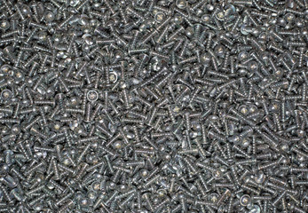 A huge arrenge of taping metal or iron screws, screws background, wallpaper, texture, industrial background and concept