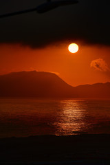 Fiery sun at sunset over pacific ocean in Peru