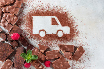 Car made of cocoa powder and chocolate on a light background. Online shopping. Concept of delivery services, logistics, cargo delivery.