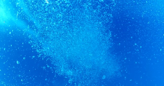 air bubbles underwater coming up in blue water ocean scenery