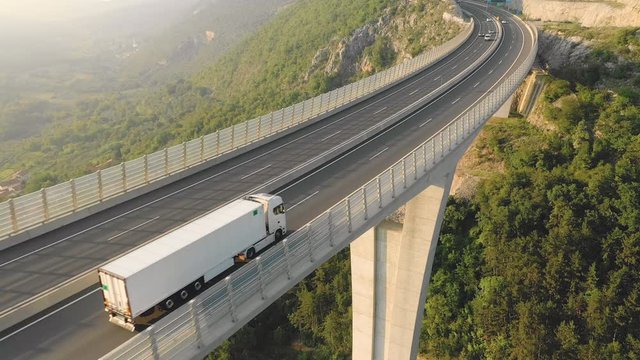 Aerial - Close-up shot of beautiful white container truck driving on highway