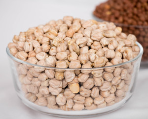 Group of white chickpeas or white chana in a bowl on a white background 