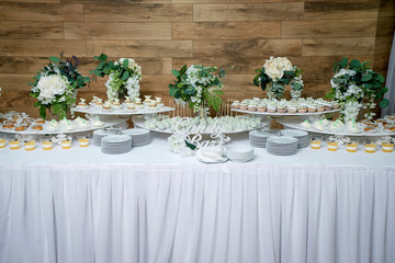 stylish luxury decorated candy bar for the celebration of a wedding of happy couple, cathering in the restaurant