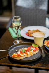 Bruschetta with cheese and tomato and glass of wine