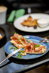 Bruschetta with ham and green and cheese