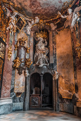 Fototapeta na wymiar St Jerome Hieronymus statue with two angels in entrance hall to Baroque church Asamkirche in Munich, Germany
