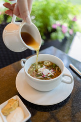 Russian cold soup okroshka on summer terrace