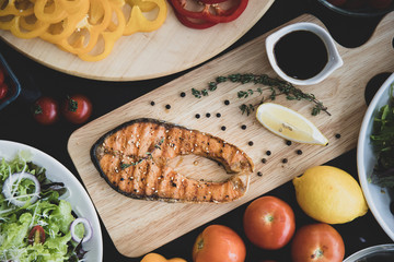 Salmon steak and vegetable salad, top view.