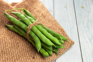 Green beans close up on wooden background