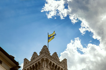 Fototapeta na wymiar Flag of Trento on Torre Civica, Italy