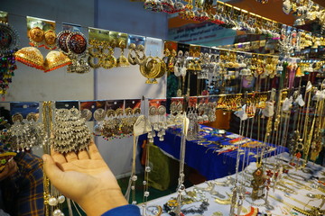 different ear rings hanging in a shop in a fair