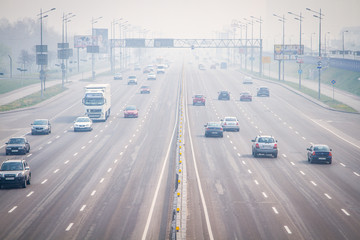 Smog, smoke and severe air pollution in Kiev. Kyiv, Kiev city street filled with traffic next to a...